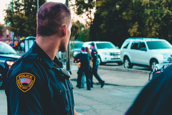 Police officer watching a detention scene